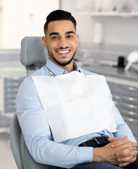 Man smiling while sitting in treatment chair