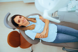 Woman leaning back in dental chair and relaxing